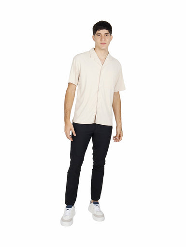 Hombre vistiendo camisa de manga corta color khaki con cuello abierto y bolsillo frontal.