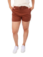 Mujer vistiendo shorts deportivos color marrón con bolsillos y cintura elástica.